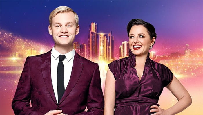 Joel Creasey and Myf Warhurst against city skyline. SBS Eurovision.